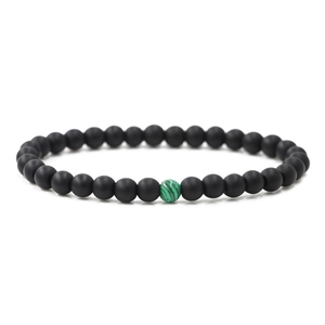 Detail of 6mm matte black stone distance bracelet with a single green malachite accent bead