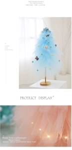 Detail of DIY mini tulle Christmas tree with warm LED lights and soft ribbon bows