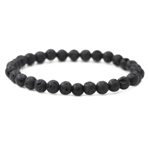 Detail of 8mm black lava stone beads on distance bracelet with porous texture