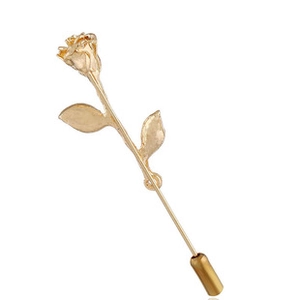 Macro shot of elegant long-stem gold rose brooch with detailed metal petals and leaves