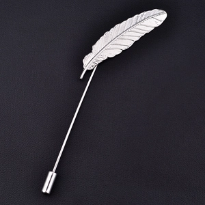 Elegant silver alloy feather brooch pin for suits, displayed on a black leather background