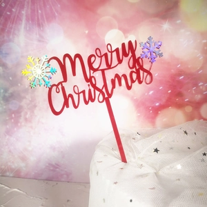 Detail of red acrylic Merry Christmas cake topper with laser snowflake on star mesh base