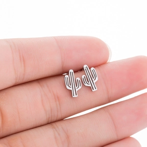 Minimalist silver cactus stud earrings for women shown in hand for size comparison