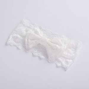 Close-up of white lace bow headband for girls with delicate texture and minimalist design