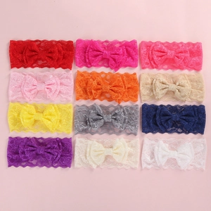 Flat lay of twelve assorted colors of lace bow headbands for babies on a pink background