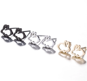 Detailed view of hollow animal-shaped stud earrings in black, silver, and gold finishes