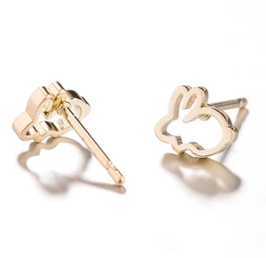 Detailed view of gold hollow rabbit stud earrings in polished stainless steel for women