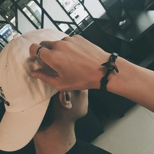Men's fashion set featuring an anchor woven bracelet, vintage ring and baseball cap