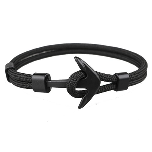 Detail of black paracord bracelet with matte black nautical anchor clasp on white background