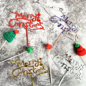 Detail of acrylic Merry Christmas cake toppers in gold silver and holographic finishes