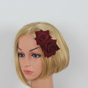 Detail view of double burgundy velvet rose hair clips worn on blonde mannequin