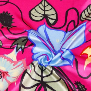 Close-up of morning glory printed satin fabric showing silky texture and vibrant colors