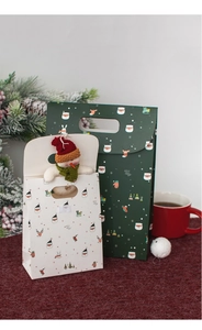 Detail of Christmas gift bags featuring green holiday patterns and 3D plush snowman decoration