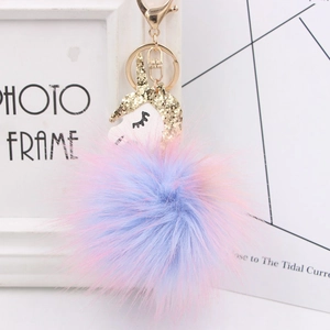 Unicorn faux fur pompom keychain with pink-purple gradient and gold sequin horn detail