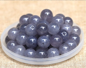 Macro view of translucent purple gemstone beads with pre-drilled holes for DIY jewelry