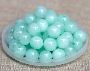 Macro shot of polished light green natural jade beads for DIY jewelry making