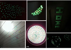 Luminous wall stickers set showing stars and moon glowing green in a dark room decor