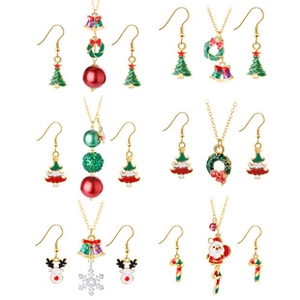 Close-up of Christmas jewelry set featuring festive enamel reindeer and snowflake patterns