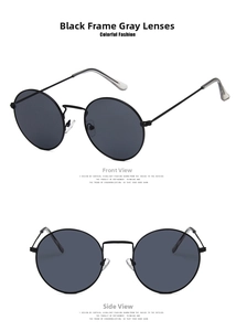 Detail view of vintage round sunglasses with black metal frames and grey lenses