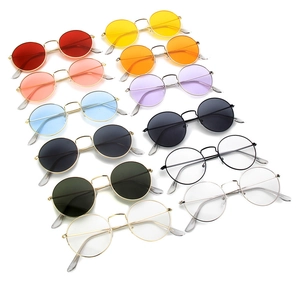 Multiple pairs of retro round metal sunglasses in various ocean colored lenses and frames