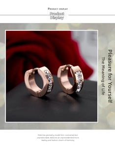 Close-up of rose gold stainless steel hoop earrings with white zircon channel settings