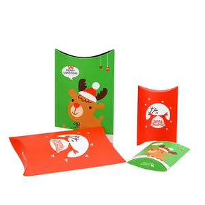 Red and green Christmas pillow gift boxes featuring cartoon reindeer and Merry Christmas text
