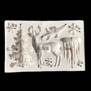 Christmas silicone mold featuring reindeer, snowflakes, and tree for cake decorating
