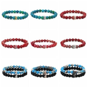 Detail view of various 8mm natural stone crown bracelets with rhinestone accents