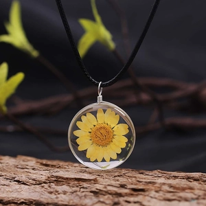 Handmade dried yellow daisy flower glass pendant on a black cord necklace