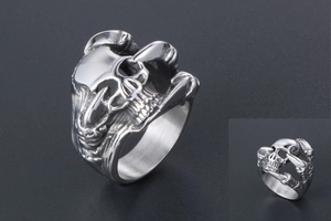 Close-up of vintage punk skull ring with detailed engravings and polished steel finish