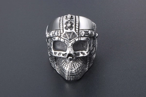 Close-up of a men's punk skull ring in silver stainless steel with detailed helmet carving