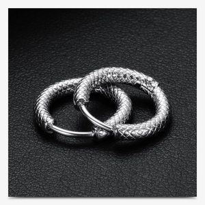 Macro shot of silver 3mm frosted snake texture earrings on black leather base