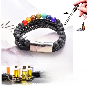 Detail showing essential oil application on black lava rock beads of a 7 chakra leather bracelet