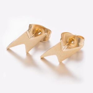 Macro shot of minimalist gold lightning bolt stud earrings with butterfly backs