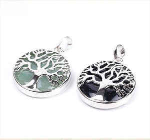 Detailed close-up of Tree of Life pendants with aventurine and blue sandstone in silver frames