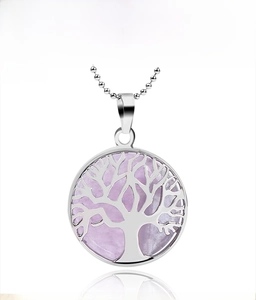 Detailed view of Tree of Life pendant featuring purple crystal in a silver-toned frame