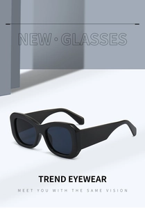 Detail of trendy wide rectangle sunglasses featuring black frames and bamboo-style legs