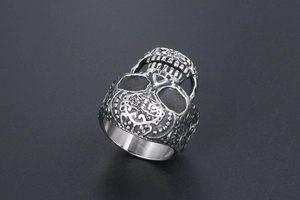 Macro detail of gothic skull ring with intricate vintage engraving and silver finish