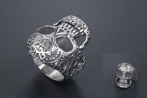 Detail shot of vintage silver skull ring with gothic relief and punk steel finish