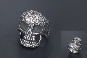 Macro detail of retro skull ring with vintage silver finish and engraved floral patterns