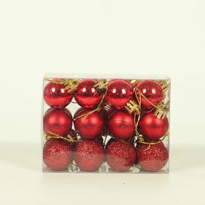 Detail of red Christmas ornaments in mirror, matte, and glitter finishes in a clear box