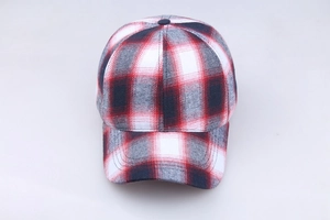 Close-up of red and navy plaid cotton fabric texture on a classic baseball cap