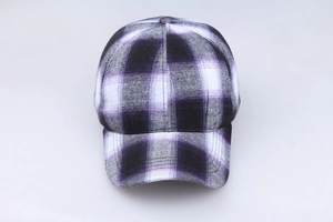 Detail view of the purple, black and white plaid cotton baseball cap fabric texture