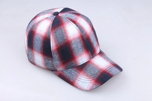 Detailed view of the red and black plaid cotton fabric texture on the baseball cap