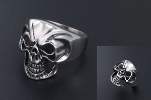 Detailed view of silver stainless steel skull ring with intricate gothic engravings