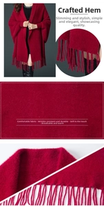 Detail of dark red faux mink cashmere shawl with fringe hem and soft knitted texture