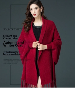 Detail of red faux mink fur cardigan with shawl collar and elegant fringe tassels