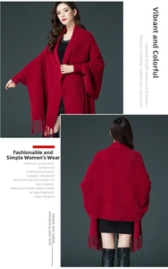 Detail of dark red knit shawl featuring long tassels and soft faux mink texture