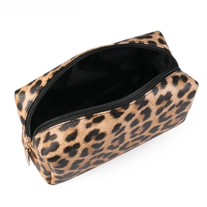 Detail view of leopard print makeup bag showing large capacity interior and gold zipper