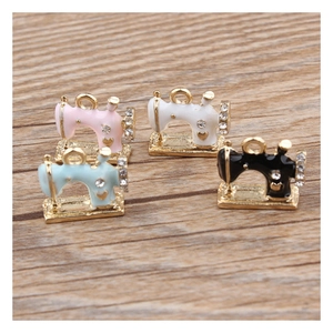 DIY enamel sewing machine charms with rhinestones in four colors on wooden background